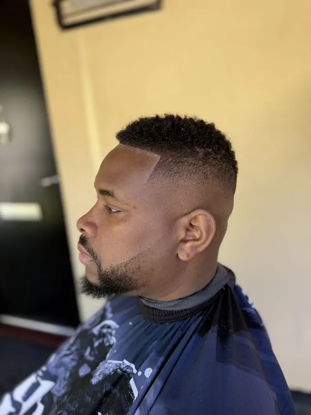 A short afro with a high fade