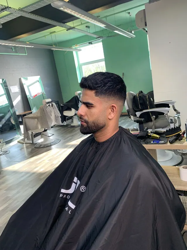 A short crop with a fade and a beard